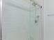 Close-up of glass-enclosed shower featuring subway tile and dual shower heads at 5302 E Van Buren St # 2015, Phoenix, AZ 85008