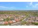 An aerial view capturing a desert community with mountain views and well-maintained streets at 5332 S Citrus Ct, Gilbert, AZ 85298