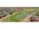 Scenic aerial view of golf course with a pond, pool, clubhouse, and lush landscaping at 5332 S Citrus Ct, Gilbert, AZ 85298