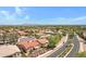 An aerial view of a neighborhood featuring homes with red tile roofs and mature trees at 5332 S Citrus Ct, Gilbert, AZ 85298
