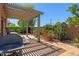 Backyard features a covered patio, desert landscaping, fountain, and grill at 5332 S Citrus Ct, Gilbert, AZ 85298