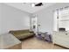 A bright bedroom offers tiled floors, a ceiling fan and window with blinds at 5332 S Citrus Ct, Gilbert, AZ 85298