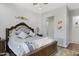 Bright bedroom features ceiling fan, with decorative pillows, a wooden framed bed, and colorful floor rug at 5332 S Citrus Ct, Gilbert, AZ 85298