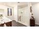 Bright bathroom featuring a glass door shower and a well-lit vanity area at 7112 N 126Th Ln, Glendale, AZ 85307