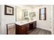 Modern bathroom featuring dual sinks and a large mirror, perfect for a Gathering at 7112 N 126Th Ln, Glendale, AZ 85307