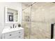 Elegant bathroom featuring a vanity with marble countertop, modern fixtures, and a glass-enclosed shower with tiled walls at 7112 N 126Th Ln, Glendale, AZ 85307