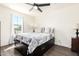 Inviting bedroom with a ceiling fan, natural light from a window, and wood floors, offering a peaceful retreat for relaxation at 7112 N 126Th Ln, Glendale, AZ 85307