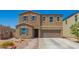 Charming two-story home featuring a desert landscape, tile roof, and attached two-car garage at 7112 N 126Th Ln, Glendale, AZ 85307