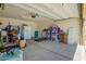 Spacious garage with a high ceiling, providing ample storage space, and potential for parking multiple vehicles or setting up a workshop at 7112 N 126Th Ln, Glendale, AZ 85307