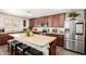 Modern kitchen featuring a large island with seating and stainless steel appliances at 7112 N 126Th Ln, Glendale, AZ 85307