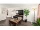 Comfortable living room with hardwood floors, large TV, and an elegant decor at 7112 N 126Th Ln, Glendale, AZ 85307