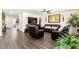 Spacious living room with a large TV, comfortable leather seating, and natural lighting at 7112 N 126Th Ln, Glendale, AZ 85307