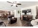 Cozy living room with a modern fireplace, hardwood floors, and an open floor plan at 7112 N 126Th Ln, Glendale, AZ 85307