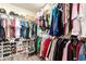 Spacious walk-in closet with ample storage, featuring shelving, hanging rods, and shoe racks for organized clothing and accessories at 7112 N 126Th Ln, Glendale, AZ 85307