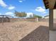 Spacious gravel backyard featuring a shed, a rock garden, and a metal canopy structure at 7146 E Bobwhite Ct, San Tan Valley, AZ 85143