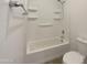 A clean bathroom features a shower-tub combo with built-in shelves and a toilet at 7146 E Bobwhite Ct, San Tan Valley, AZ 85143