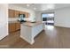 Bright, open kitchen featuring an island, modern appliances, and sliding glass door for seamless indoor-outdoor living at 7146 E Bobwhite Ct, San Tan Valley, AZ 85143