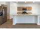 Well-appointed kitchen featuring stainless steel appliances, a spacious island and wood cabinets with granite counters at 7146 E Bobwhite Ct, San Tan Valley, AZ 85143