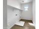 Well-lit laundry room with modern hookups and a utility sink, designed for efficiency at 7146 E Bobwhite Ct, San Tan Valley, AZ 85143