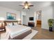 Relaxing main bedroom featuring a cozy bed with a plush rug, soft lighting and ensuite bathroom access at 7146 E Bobwhite Ct, San Tan Valley, AZ 85143