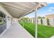View of the backyard with a covered patio, lush green lawn, and well-maintained landscaping and tall privacy wall at 7648 N Via Del Paraiso --, Scottsdale, AZ 85258