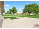 Rear exterior of a home featuring a well maintained backyard, green lawn and mature trees at 7648 N Via Del Paraiso --, Scottsdale, AZ 85258