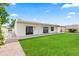 Spacious backyard with a covered patio, green lawn, providing an ideal outdoor living space and privacy wall at 7648 N Via Del Paraiso --, Scottsdale, AZ 85258