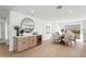 Elegant dining area featuring a fireplace, adjacent to an open kitchen and bar at 7648 N Via Del Paraiso --, Scottsdale, AZ 85258