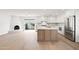 Inviting open-concept living space with a modern kitchen, cozy fireplace, and access to the backyard at 7648 N Via Del Paraiso --, Scottsdale, AZ 85258