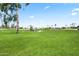 Community park featuring playground equipment, lush green grass, and mature trees and beautiful desert palms at 7648 N Via Del Paraiso --, Scottsdale, AZ 85258