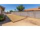 Spacious backyard featuring a brick fence, desert landscaping, and potential for customization at 8020 W Windrose Dr, Peoria, AZ 85381