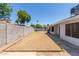 Open backyard is ready to be customized for outdoor living, featuring desert landscaping and a brick fence at 8020 W Windrose Dr, Peoria, AZ 85381
