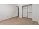Cozy bedroom with closet and carpeted floors; door to adjacent rooms visible at 8020 W Windrose Dr, Peoria, AZ 85381