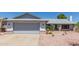 Charming single-story home with a spacious two-car garage and desert landscaping at 8020 W Windrose Dr, Peoria, AZ 85381