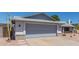 Two car garage with neutral tone, matching the exterior of the home at 8020 W Windrose Dr, Peoria, AZ 85381