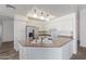 A lovely kitchen features white cabinets, counter seating, and stainless-steel appliances at 8020 W Windrose Dr, Peoria, AZ 85381