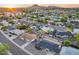 Panoramic aerial view featuring a neighborhood with houses, mature trees, and mountain views at 8117 E Lewis Ave, Scottsdale, AZ 85257