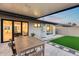 Backyard patio with a dining table and a artificial turf area at 8117 E Lewis Ave, Scottsdale, AZ 85257