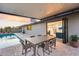 Backyard patio has a swimming pool, a dining table, and views of the living area at 8117 E Lewis Ave, Scottsdale, AZ 85257