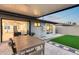 Backyard patio with a dining table and a artificial turf area at 8117 E Lewis Ave, Scottsdale, AZ 85257