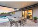 Backyard patio has a swimming pool, a dining table, and views of the living area at 8117 E Lewis Ave, Scottsdale, AZ 85257