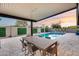 Covered backyard patio has a swimming pool, desert landscaping and plenty of space for outdoor dining at 8117 E Lewis Ave, Scottsdale, AZ 85257