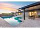 Inviting backyard featuring a refreshing pool, covered patio with dining area and lush greenery at 8117 E Lewis Ave, Scottsdale, AZ 85257