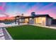 Spacious backyard showcasing a refreshing pool, covered patio, manicured lawn, and modern finishes at 8117 E Lewis Ave, Scottsdale, AZ 85257