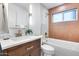 Updated bathroom features a modern vanity, stylish mirror, and a tub with tiled walls at 8117 E Lewis Ave, Scottsdale, AZ 85257