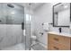 Modern bathroom featuring a glass-enclosed shower with tile surround, vanity, and contemporary fixtures at 8117 E Lewis Ave, Scottsdale, AZ 85257