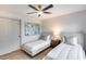 Well-lit bedroom featuring two twin beds, a ceiling fan, and stylish decor at 8117 E Lewis Ave, Scottsdale, AZ 85257