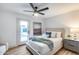 Serene bedroom with a ceiling fan, ensuite door to patio, and modern furnishings at 8117 E Lewis Ave, Scottsdale, AZ 85257