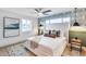 Bright bedroom featuring a large bed, ceiling fan, patterned wallpaper, and plenty of natural light at 8117 E Lewis Ave, Scottsdale, AZ 85257