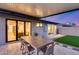 Cozy covered patio with dining set and views of backyard and house at 8117 E Lewis Ave, Scottsdale, AZ 85257